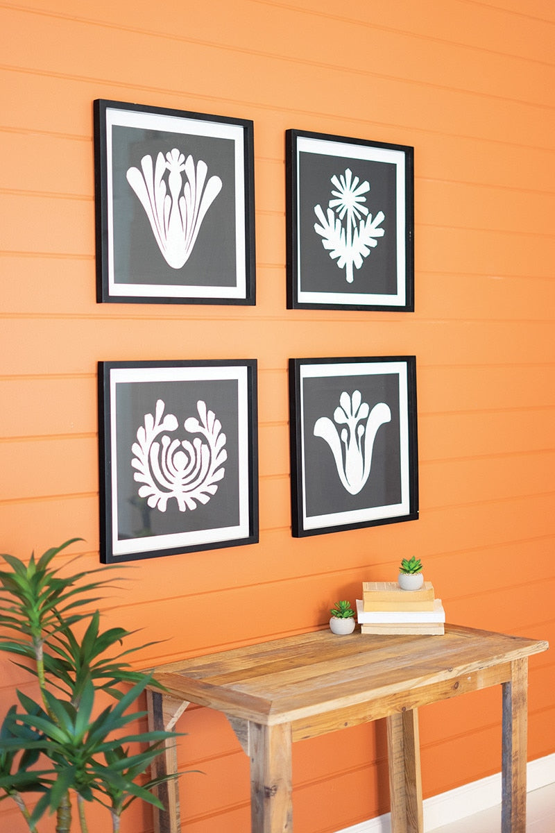 Framed black and white graphic prints under glass