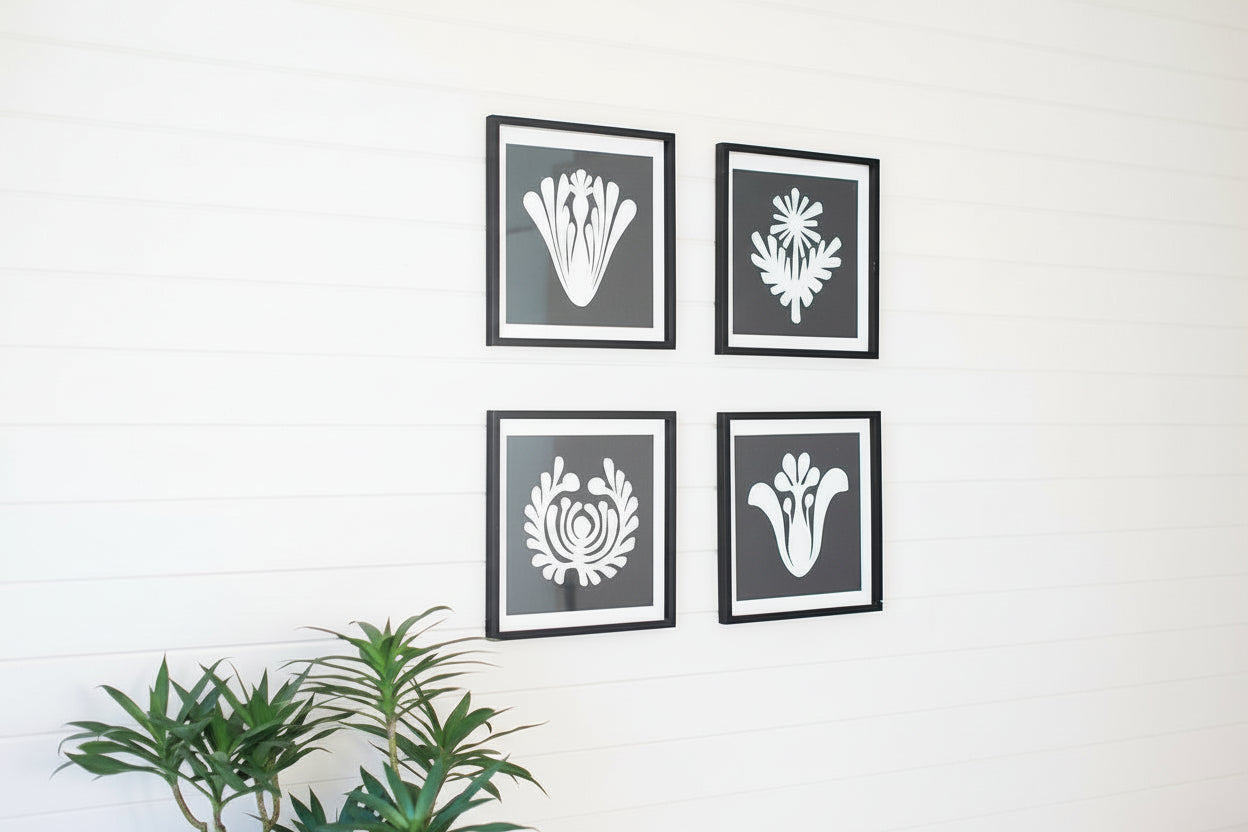 Framed black and white graphic prints under glass