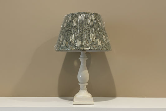 White pedestal style lamp with green William Morris lamp shade