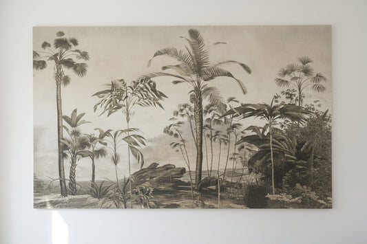 A wall mural featuring a vintage reproduction of a palm tree landscape, with a lamp and decorative items in the foreground.